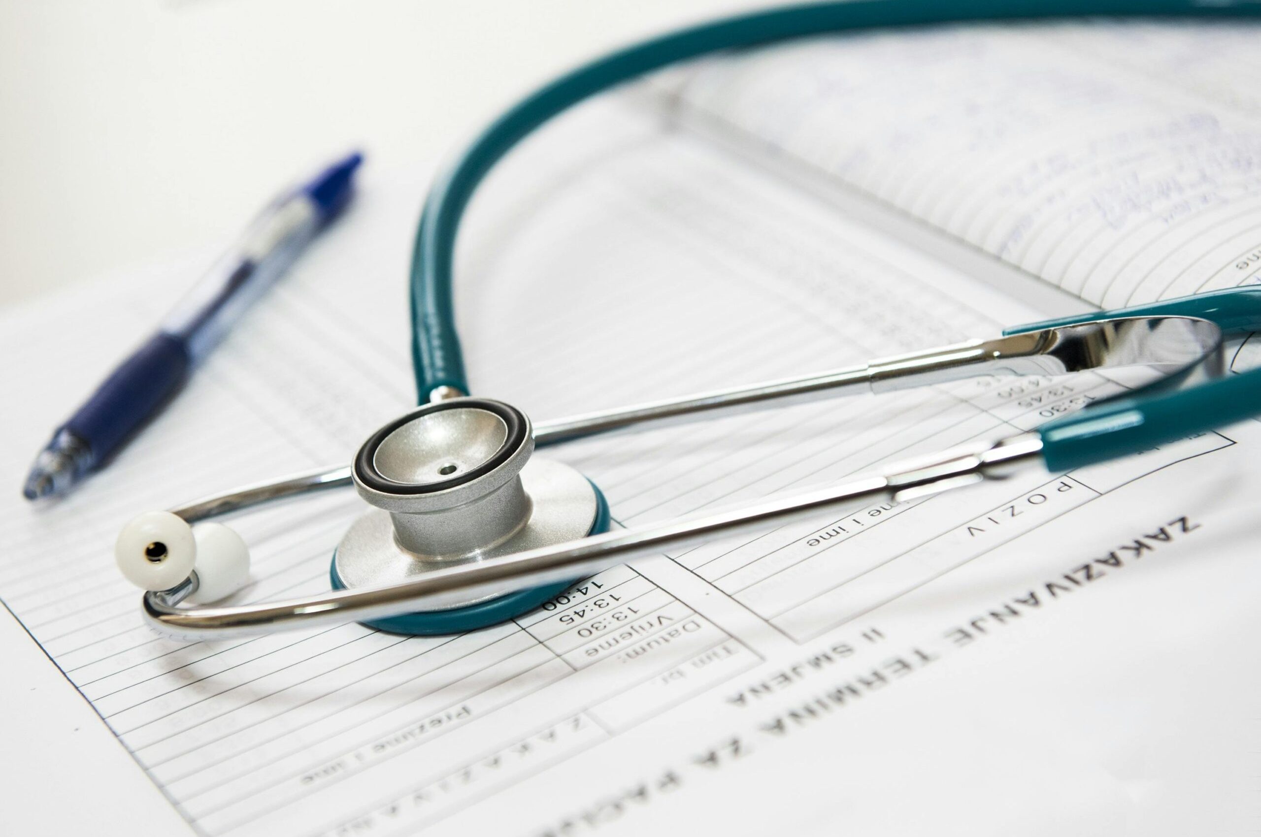 medical-appointment-doctor-healthcare-40568-40568 A stethoscope and pen resting on a medical report in a healthcare setting.