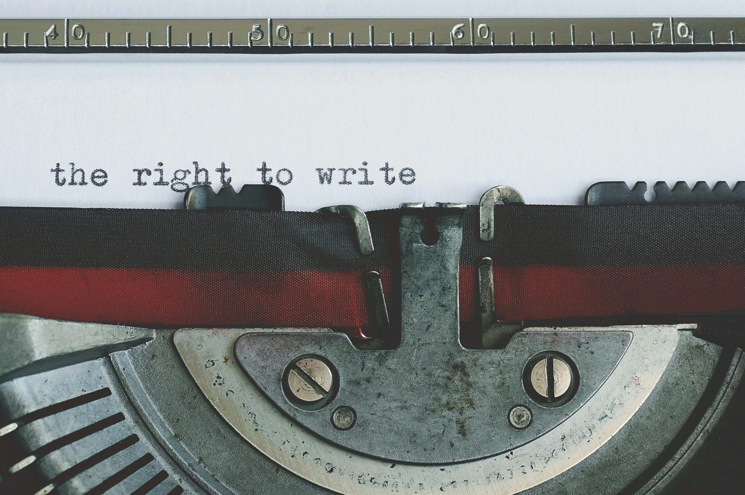 pexels-photo-3604571-3604571 Close-up of a vintage typewriter with 'the right to write' typed on paper.