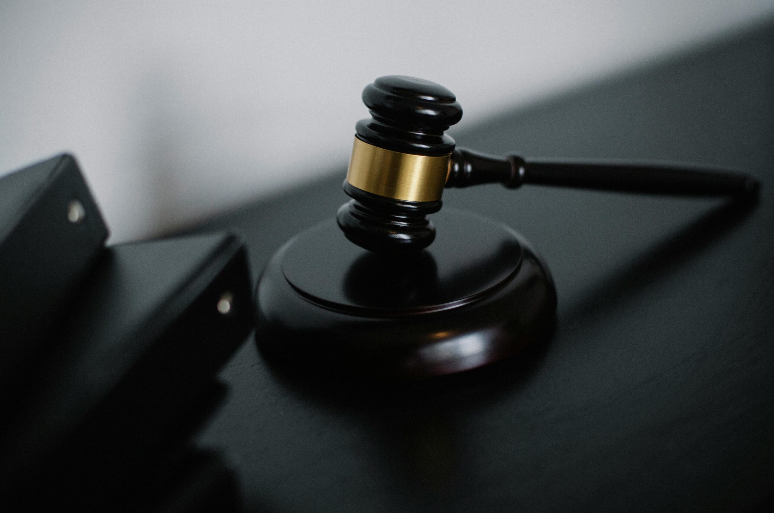 pexels-photo-5668473-5668473 Close-up of a wooden gavel on a desk, symbolizing justice and legal authority.